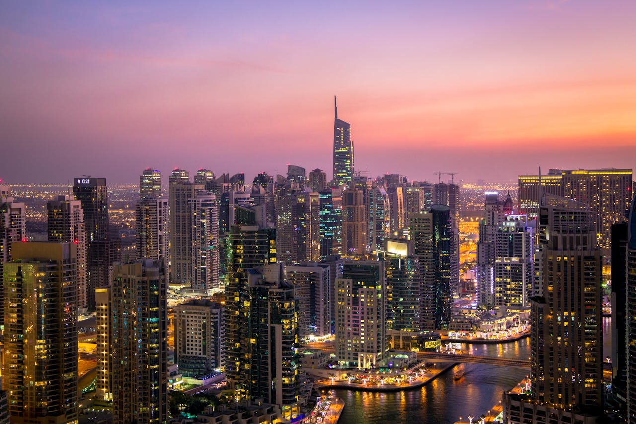 Captivating view of Dubais skyline at dusk with vibrant city lights and skyscrapers.